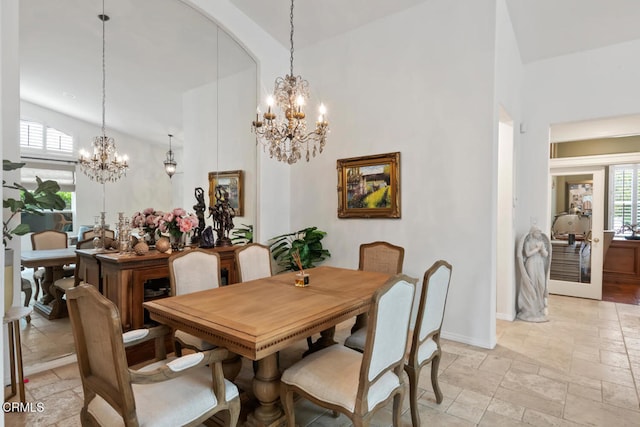 dining room with a chandelier, a wealth of natural light, high vaulted ceiling, and stone tile floors