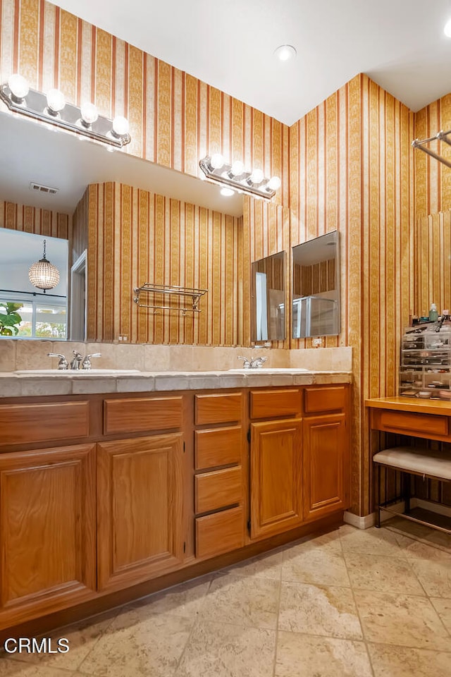 bathroom featuring recessed lighting, visible vents, a sink, and double vanity