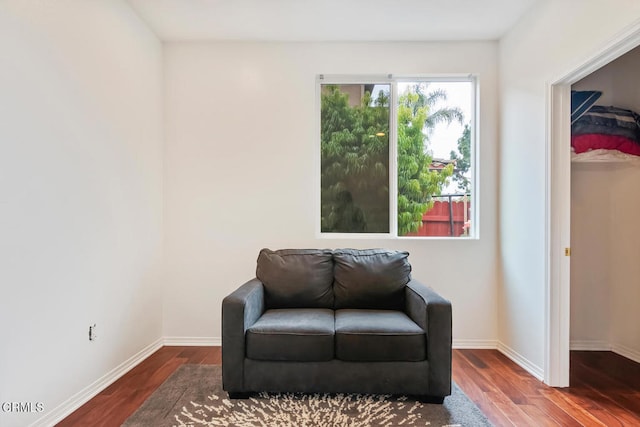 sitting room featuring baseboards and wood finished floors
