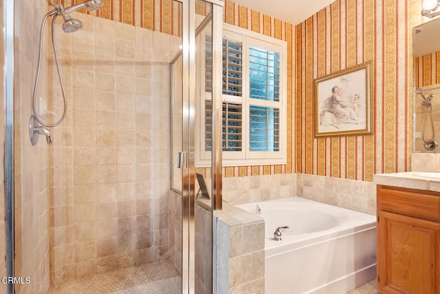 bathroom featuring wallpapered walls, vanity, a shower stall, and a garden tub