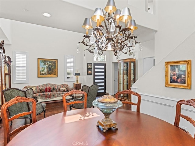 dining room featuring a chandelier, plenty of natural light, and wood finished floors