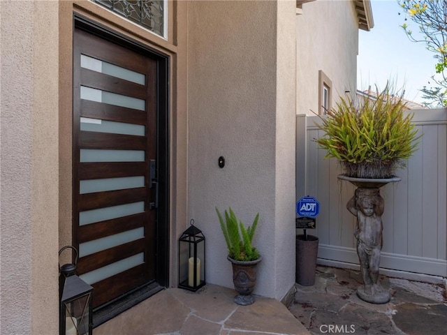 view of exterior entry with stucco siding