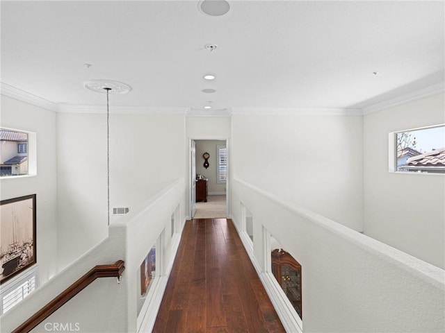 hall with crown molding, wood-type flooring, and recessed lighting