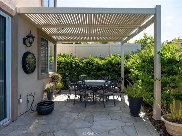 view of patio / terrace with outdoor dining area, a pergola, and fence