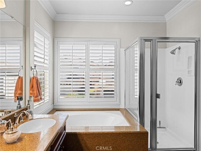 bathroom featuring healthy amount of natural light, ornamental molding, a shower stall, and a garden tub
