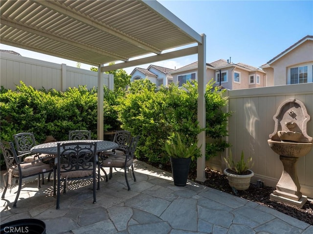 view of patio featuring outdoor dining space and fence