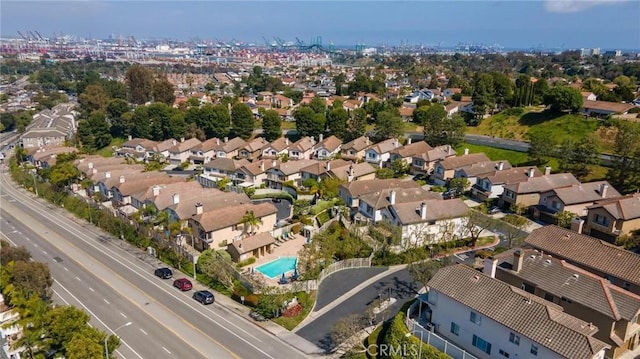 view of property location with nearby suburban area and a pool