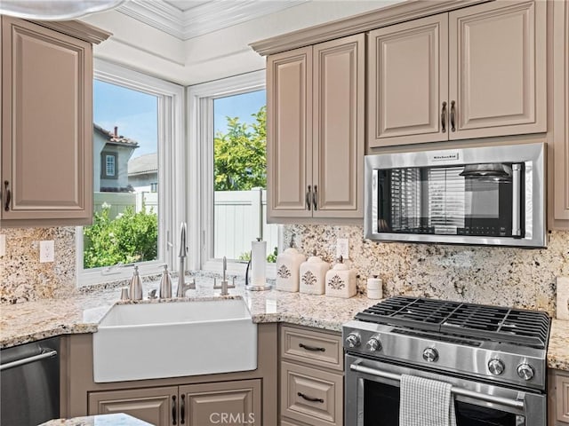 kitchen with stainless steel appliances, a sink, decorative backsplash, crown molding, and light stone counters