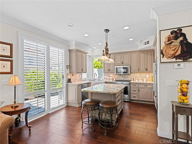 kitchen with stainless steel appliances, a kitchen island, tasteful backsplash, dark wood-style floors, and crown molding