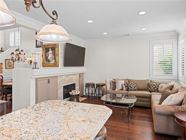living area with ornamental molding, dark wood-style floors, a high end fireplace, and recessed lighting