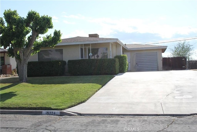 single story home with fence, concrete driveway, a garage, stucco siding, and a front lawn