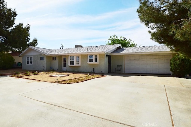 ranch-style home featuring stucco siding, driveway, and a garage