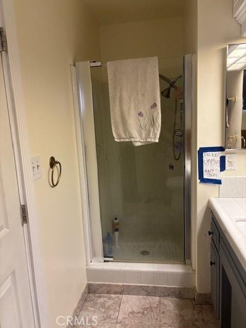 full bathroom with a stall shower and vanity
