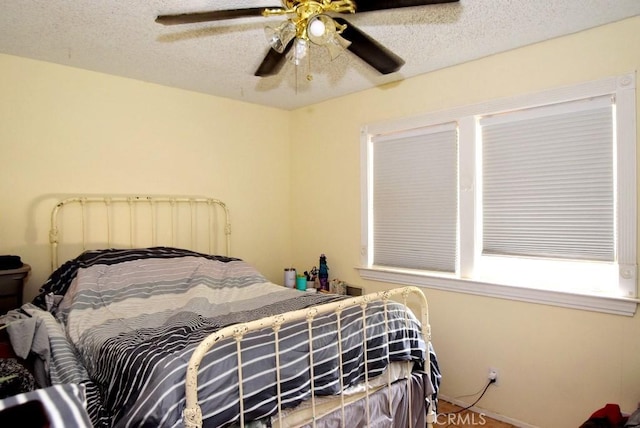 bedroom featuring ceiling fan and a textured ceiling