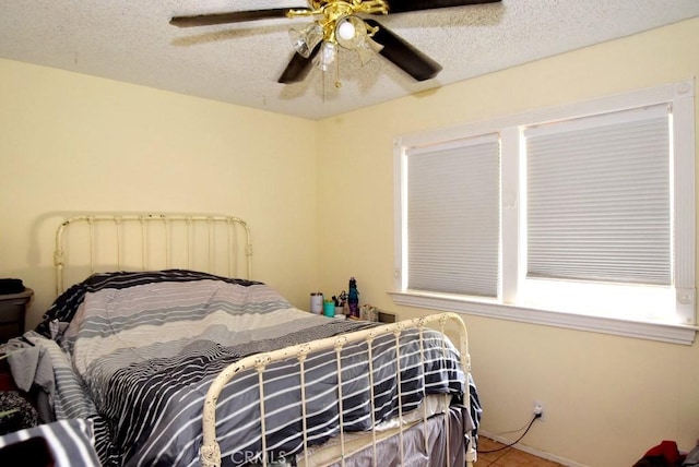 56819 Mountain View Trl, Yucca Valley, CA 92284 - tiled bedroom with a ceiling fan and a textured ceiling