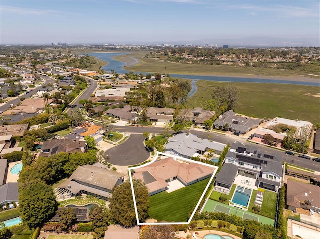 birds eye view of property featuring a water view and a residential view