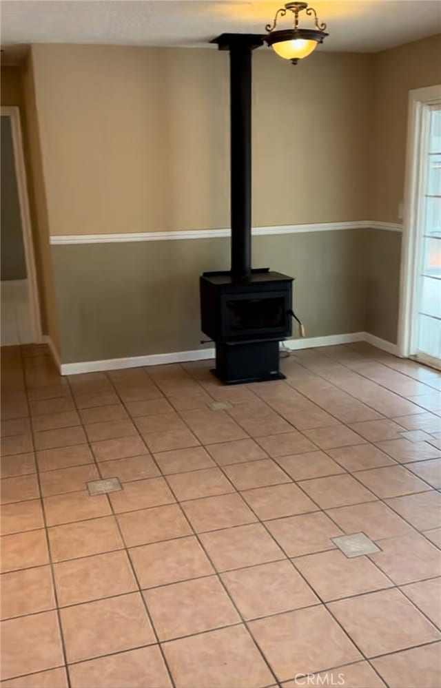 details featuring a wood stove and baseboards