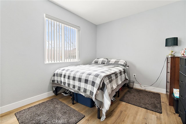 1301 E Pacific Coast, Wilmington, CA 90744 - bedroom featuring baseboards and wood finished floors