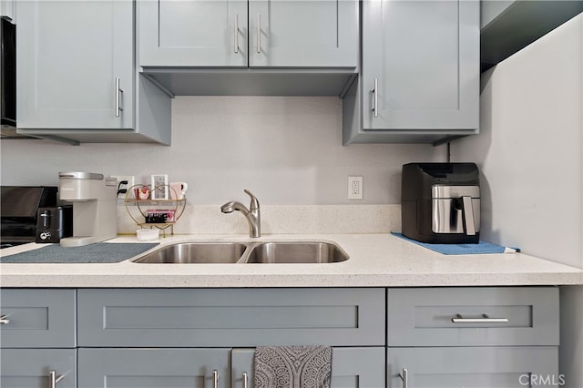 1301 E Pacific Coast, Wilmington, CA 90744 - kitchen featuring gray cabinets, a sink, and light stone counters