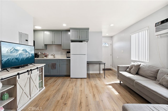 1301 E Pacific Coast, Wilmington, CA 90744 - kitchen with freestanding refrigerator, gray cabinetry, light wood finished floors, light countertops, and recessed lighting