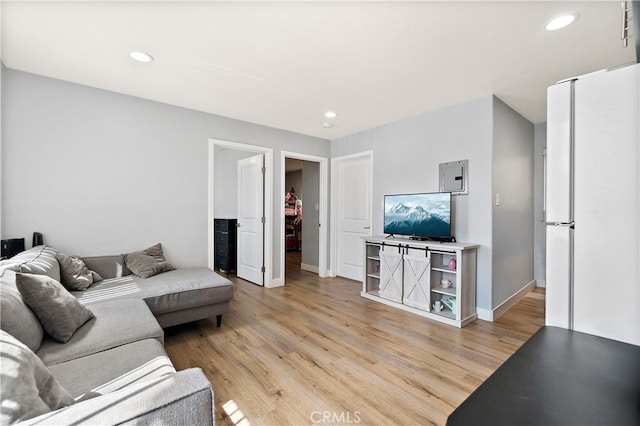 1301 E Pacific Coast, Wilmington, CA 90744 - living area featuring light wood finished floors, recessed lighting, electric panel, and baseboards