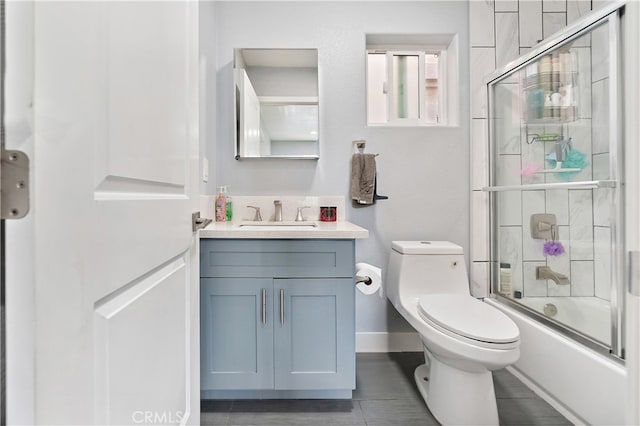 1301 E Pacific Coast, Wilmington, CA 90744 - full bathroom with vanity, toilet, bath / shower combo with glass door, tile patterned flooring, and baseboards