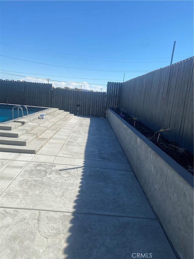 631 Chateau Way, Barstow, CA 92311 - exterior space with an outdoor pool and a fenced backyard