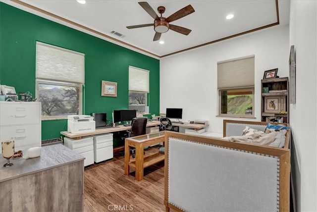 home office featuring plenty of natural light, visible vents, wood finished floors, and ceiling fan