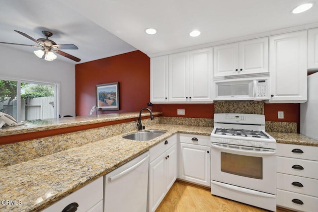 kitchen with ceiling fan, white cabinets, a sink, and white appliances