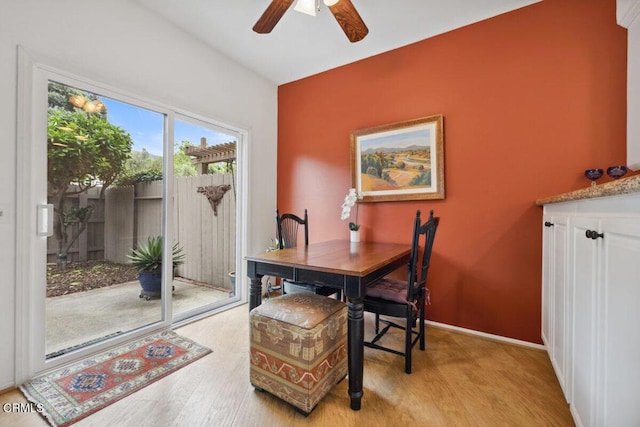 dining room featuring ceiling fan, baseboards, and wood finished floors