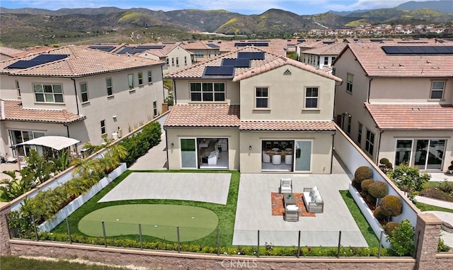 109 Chronology, Irvine, CA 92618 - rear view of property featuring a putting green, a residential view, stucco siding, and a tiled roof
