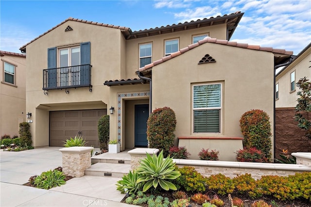 109 Chronology, Irvine, CA 92618 - view of front of house featuring stucco siding, a balcony, a tiled roof, a garage, and concrete driveway