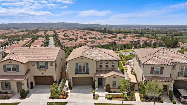 109 Chronology, Irvine, CA 92618 - view of front facade with a residential view, an attached garage, concrete driveway, and stucco siding