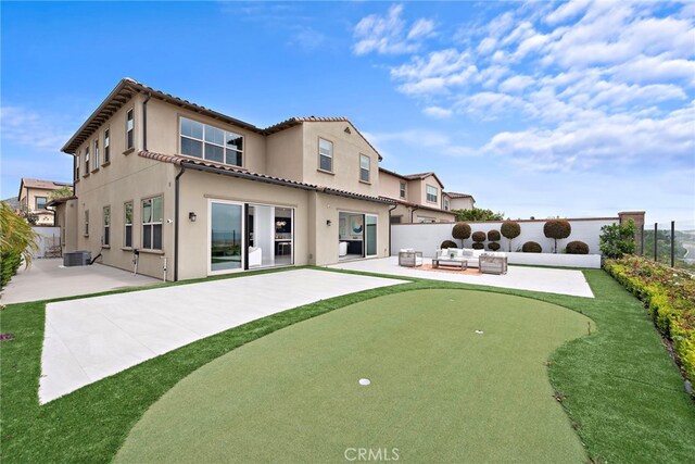 109 Chronology, Irvine, CA 92618 - back of property with a putting green, a patio, a fenced backyard, a tile roof, and stucco siding