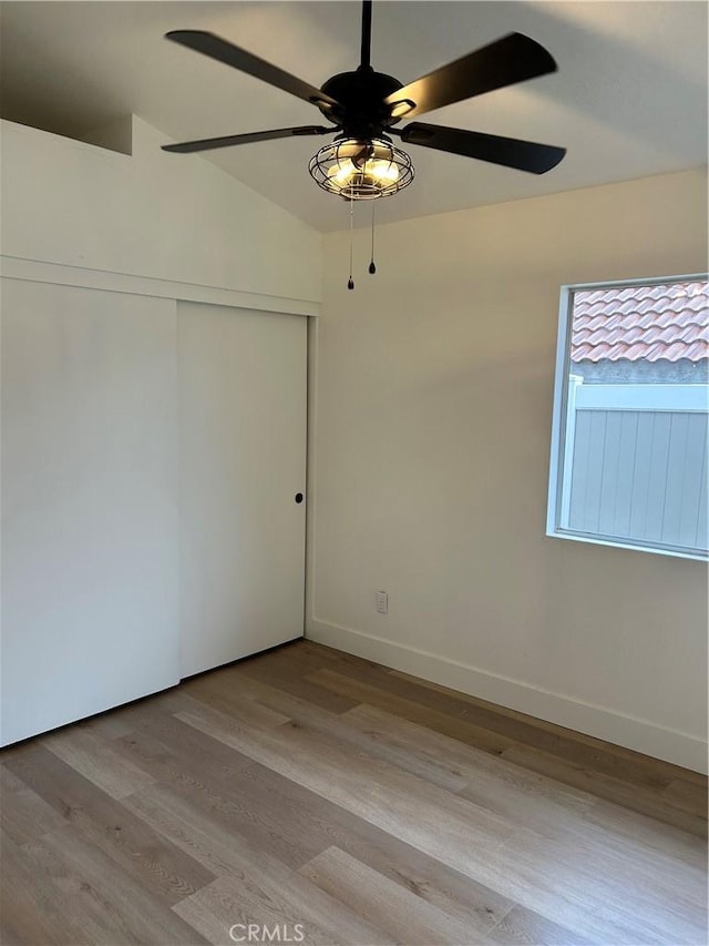 unfurnished room with baseboards, a ceiling fan, and light wood-style floors
