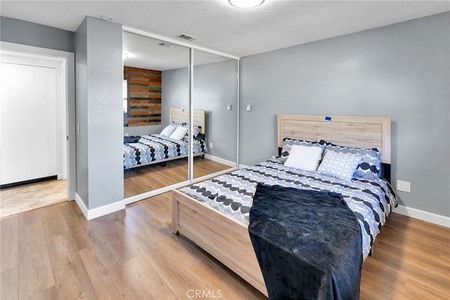 18343 Cocopah Ct, Apple Valley, CA 92307 - bedroom featuring a closet, visible vents, wood finished floors, and baseboards