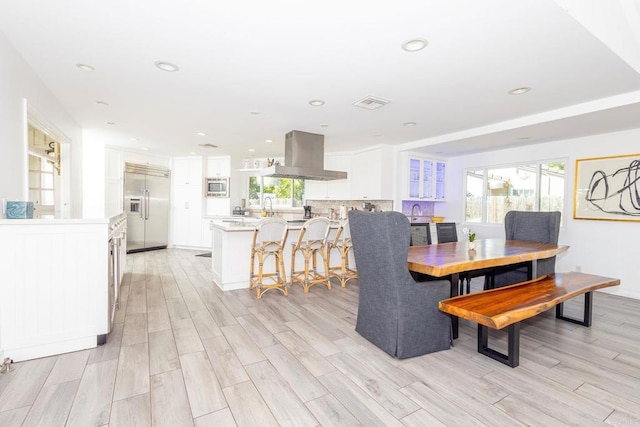 dining area featuring light wood-style floors, visible vents, and recessed lighting