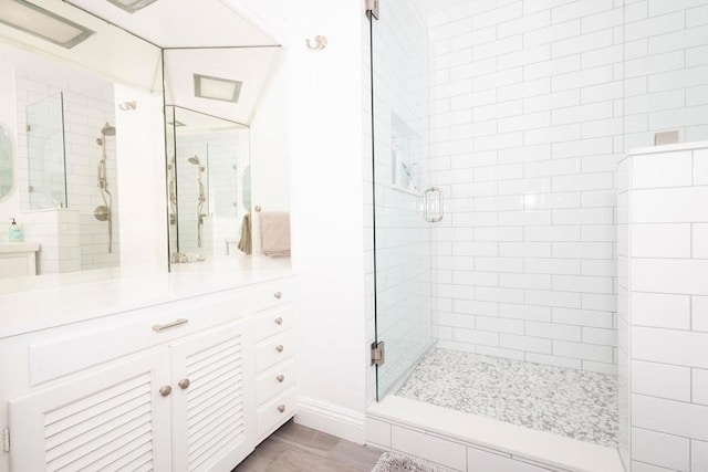 bathroom with a stall shower and vanity