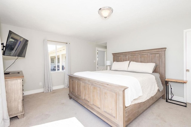 bedroom featuring light colored carpet and baseboards