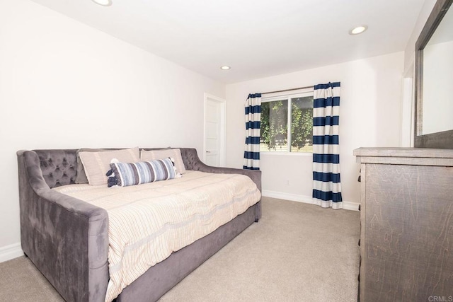 carpeted bedroom featuring baseboards and recessed lighting