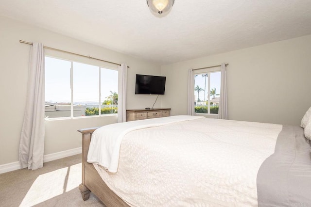 carpeted bedroom featuring baseboards