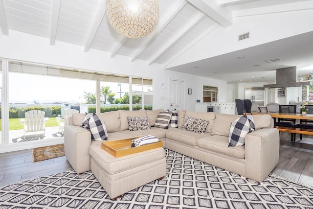 living room featuring a chandelier, visible vents, wood finished floors, and lofted ceiling with beams