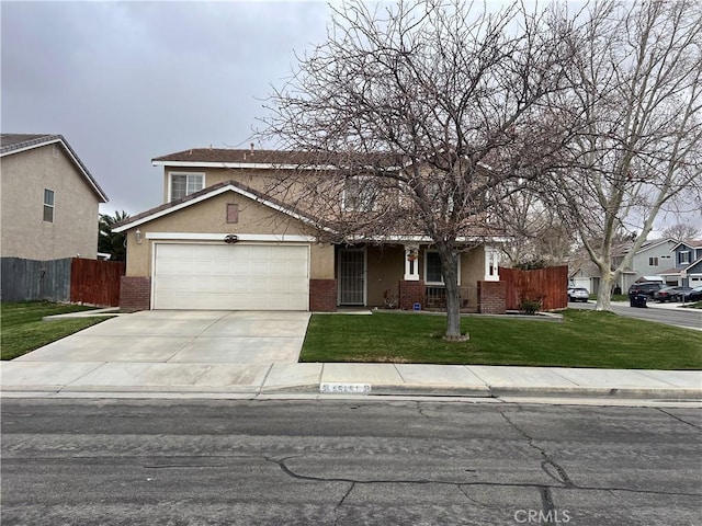 traditional-style house with fence, concrete driveway, a garage, stucco siding, and a front lawn
