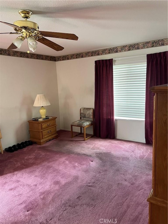 interior space with carpet flooring and a ceiling fan