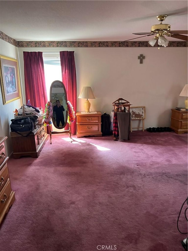 interior space featuring a ceiling fan and carpet floors