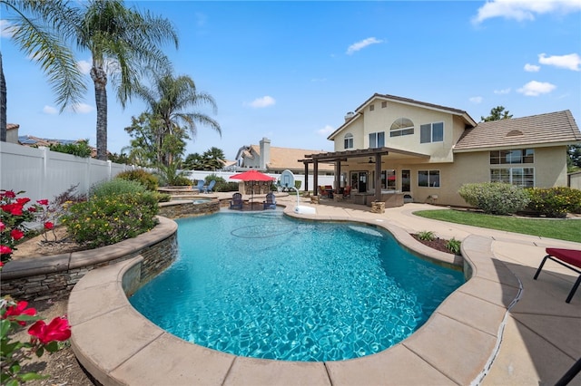 view of pool with a patio, a fenced backyard, a fenced in pool, an in ground hot tub, and an outdoor kitchen