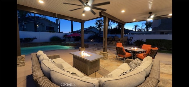 view of patio / terrace featuring a fenced in pool, a fire pit, ceiling fan, and a fenced backyard