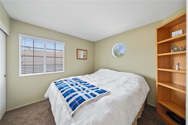 bedroom with carpet flooring and baseboards