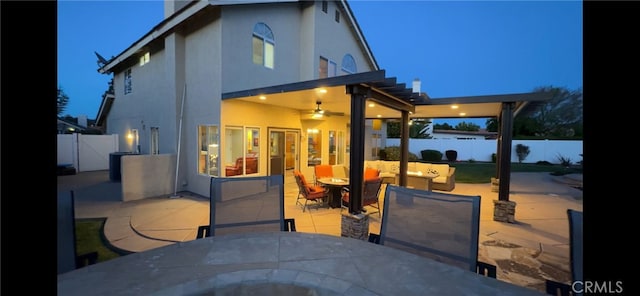 back of property featuring a patio area, stucco siding, outdoor dining area, and a fenced backyard