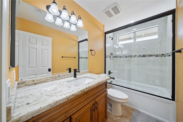 full bathroom featuring toilet, vanity, visible vents, tile patterned flooring, and shower / bath combination with glass door